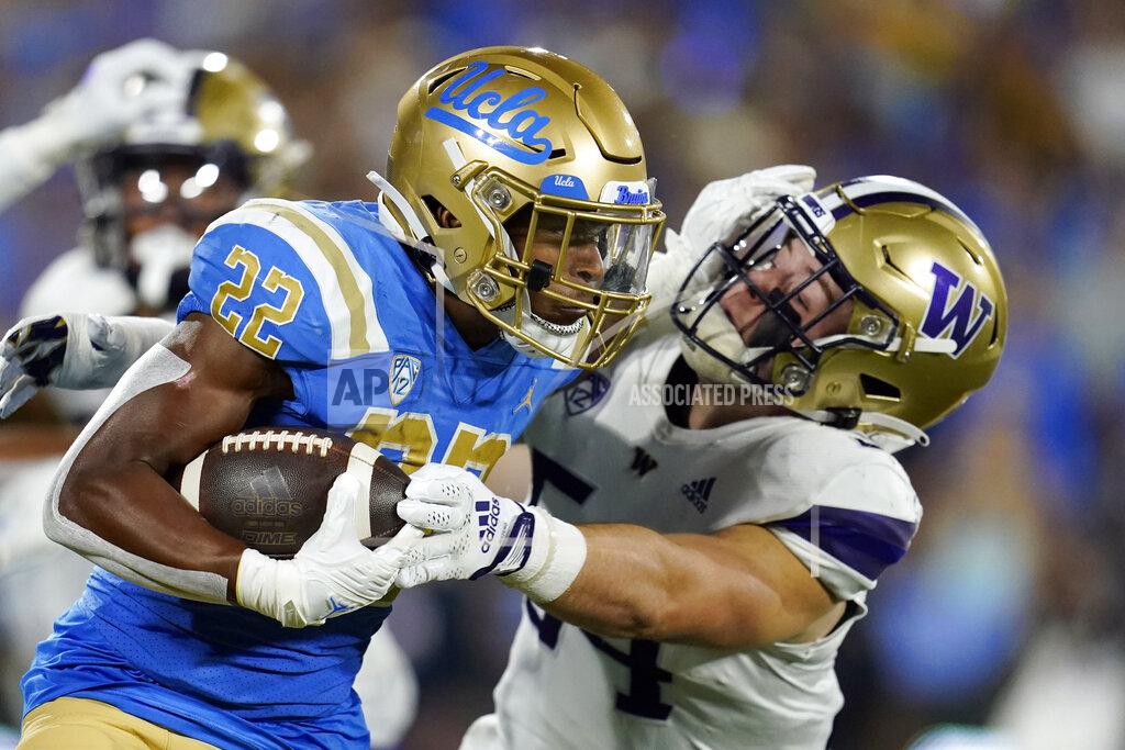 Marcio Jose Sanchez UCLA's Keegan Jones (22) stiff-arms Washington's Drew Fowler on a kick return during the first half of an NCAA college football game Friday, Sept. 30, 2022, in Pasadena, Calif. (AP Photo/Marcio Jose Sanchez)