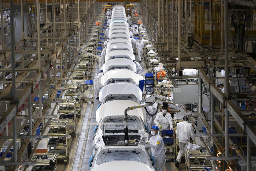 Ng Han Guan In this April 8, 2020, photo, employees work on a car assembly line at the Dongfeng Honda Automobile Co., Ltd factory in Wuhan in central China's Hubei province. The United States, Japan and France are prodding their companies to rely less on China to make the world’s smartphones, drugs and other products. But even after the coronavirus derailed global trade, few are willing to give up access to its skilled workers, vast market and efficient suppliers by moving factories closer to home. (AP Photo/Ng Han Guan)