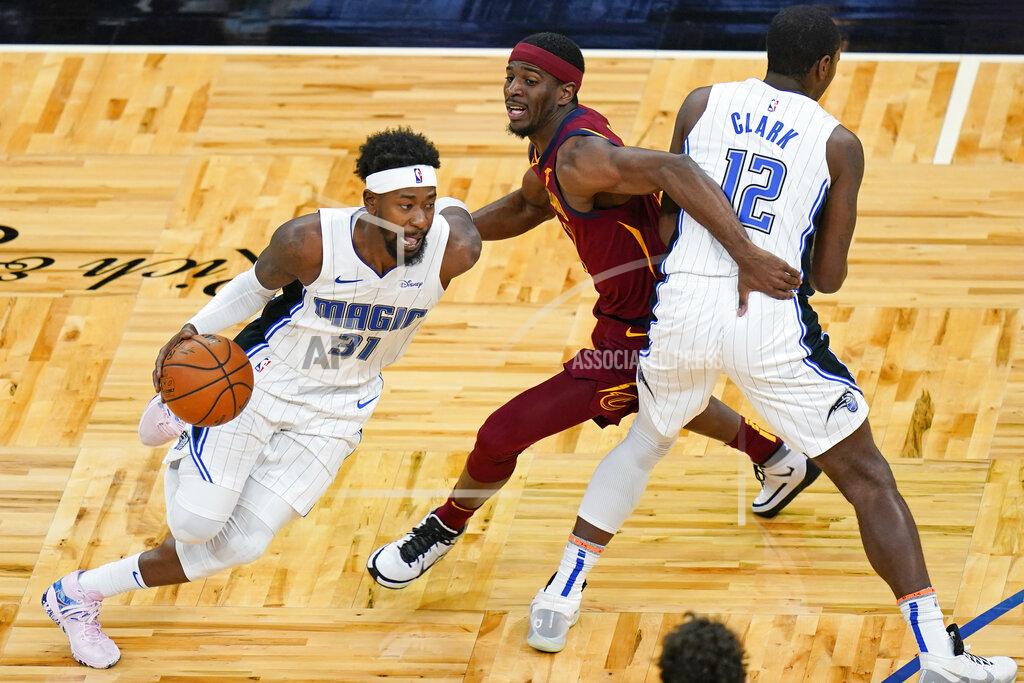 John Raoux Orlando Magic guard Terrence Ross (31) drives around Cleveland Cavaliers guard Damyean Dotson, center, as forward Gary Clark (12) sets a pick during the second half of an NBA basketball game, Monday, Jan. 4, 2021, in Orlando, Fla. (AP Photo/John Raoux)