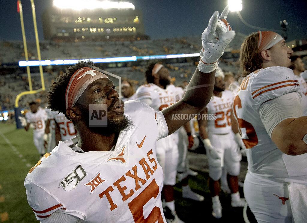 Nick Wagner Texas defensive back D'Shawn Jamison (5) holds up the "Hook 'Em Horns" gesture after Texas defeated West Virginia in an NCAA college football game on Saturday, Oct. 5, 2019, in Morgantown, W. Va. (Nick Wagner/Austin American-Statesman via AP)