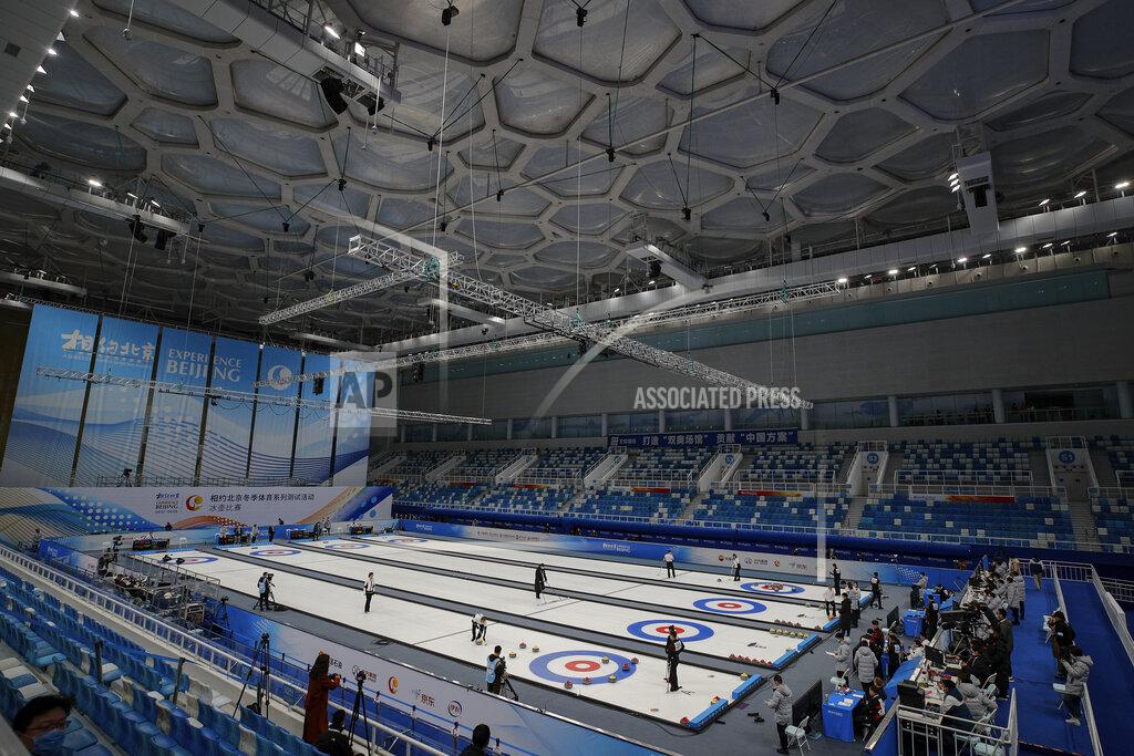 Andy Wong Local team players compete in a curling competition during a test event for the 2022 Beijing Winter Olympics at National Aquatic Center, also known as the "Water Cube" in Beijing, Thursday, April 1, 2021. Chinese capital holds 10 days test events for 2022 Beijing Winter Olympics in five different venues from April 1-10 and becomes the first city to hold both the Winter and Summer Olympics. (AP Photo/Andy Wong)