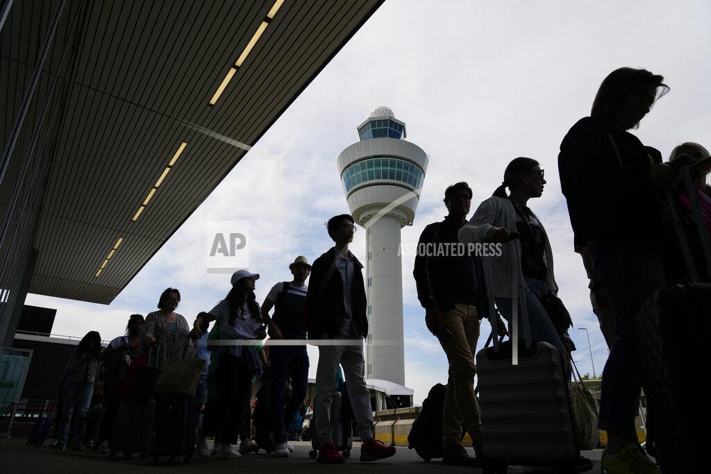 Peter Dejong FILE - Travelers wait in long lines outside the terminal building to check in and board flights at Amsterdam's Schiphol Airport, Netherlands, Tuesday, June 21, 2022. After two years of pandemic restrictions, travel demand is back with a vengeance but airlines and airports that slashed jobs during the depths of the COVID-19 crisis are struggling to keep up. With the busy summer tourism season underway in Europe, passengers are encountering chaotic scenes at airports, including lengthy delays, canceled flights and headaches over lost luggage. (AP Photo/Peter Dejong, File)