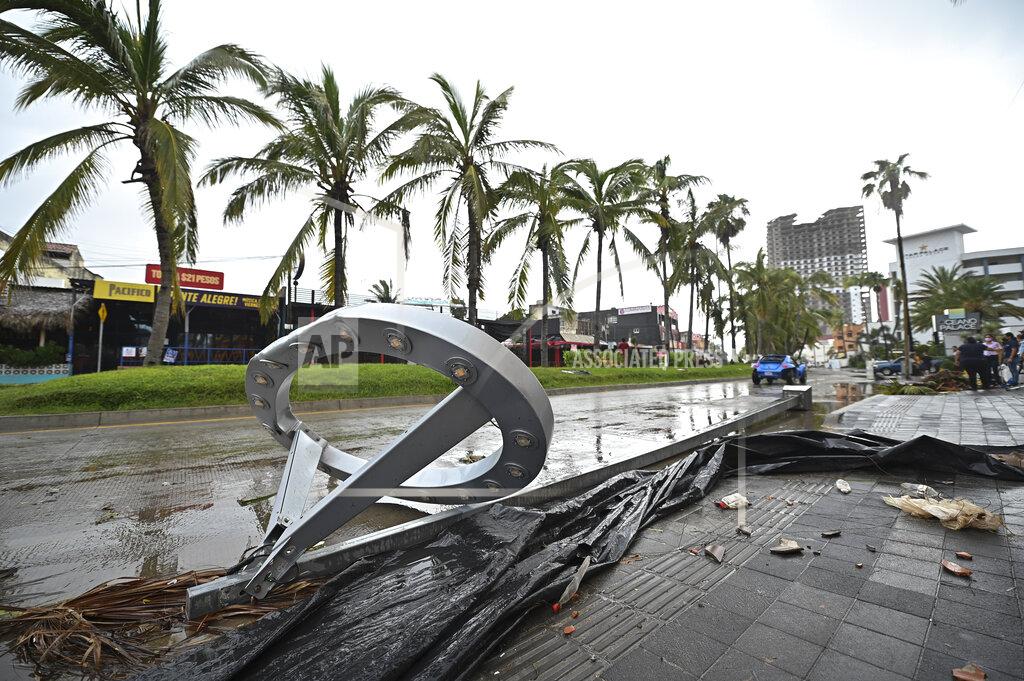 Roberto Echeagaray Toppled lamp posts lay on the side of a road after the passing of Hurricane Pamela in Mazatlan, Mexico, Wednesday, Oct. 13, 2021. Pamela made landfall on Mexico's Pacific coast just north of Mazatlan on Wednesday, bringing high winds and rain to the port city. (AP Photo/Roberto Echeagaray)