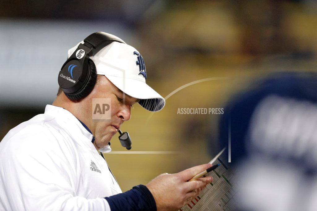 Gerald Herbert Rice head coach Mike Bloomgren reads his chart on the sideline in the second half of an NCAA college football game against LSU in Baton Rouge, La., Saturday, Nov. 17, 2018. (AP Photo/Gerald Herbert)