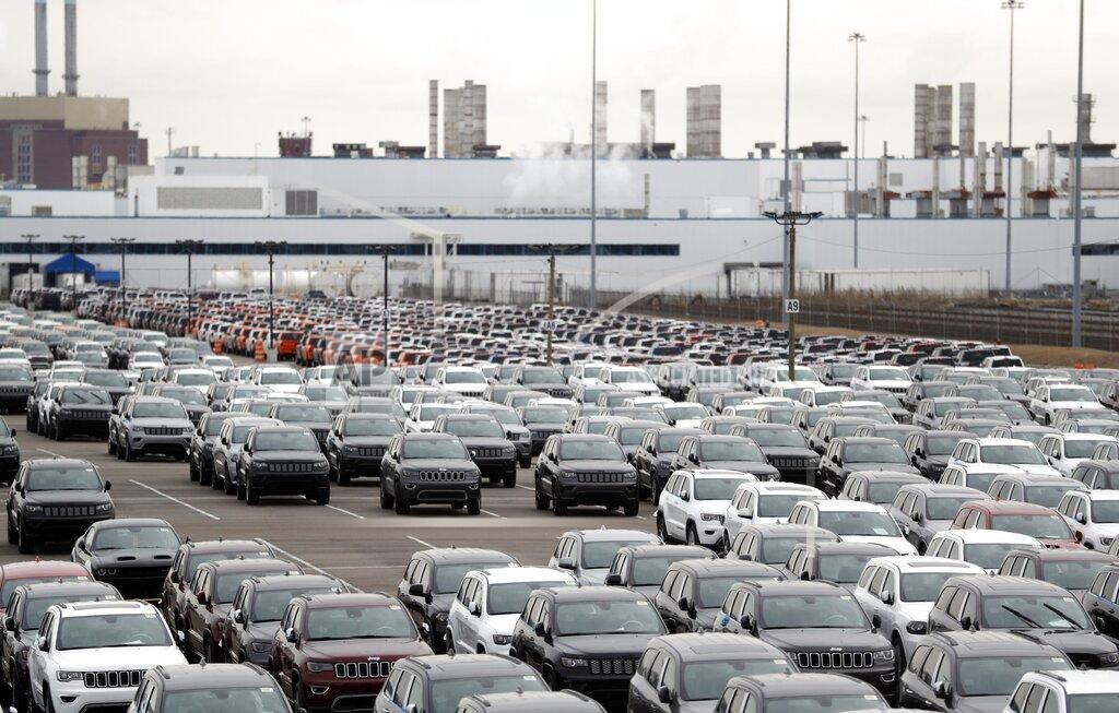 FILE - In this Feb. 26, 2019 file photo, Jeep vehicles are parked outside the Jefferson North Assembly Plant in Detroit. Major U.S. automakers are planning to reopen North American factories within two weeks, potentially putting thousands of workers back on the assembly line, as part of a gradual return to normality. Fiat Chrysler CEO Mike Manley said Tuesday, May 5, 2020, his company plans to start reopening factories May 18 depending on easing of government restrictions. (AP Photo/Carlos Osorio, File)