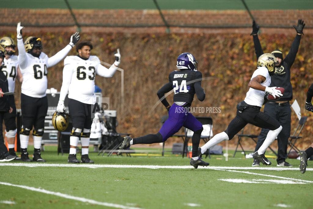Paul Beaty Purdue wide receiver Milton Wright (0) sprints his way to a touchdown, ahead of Northwestern's Rod Heard II (24), after catching a pass during the second half of a NCAA football game Nov. 20, 2021 at Wrigley Field in Chicago.(AP Photo/Paul Beaty)