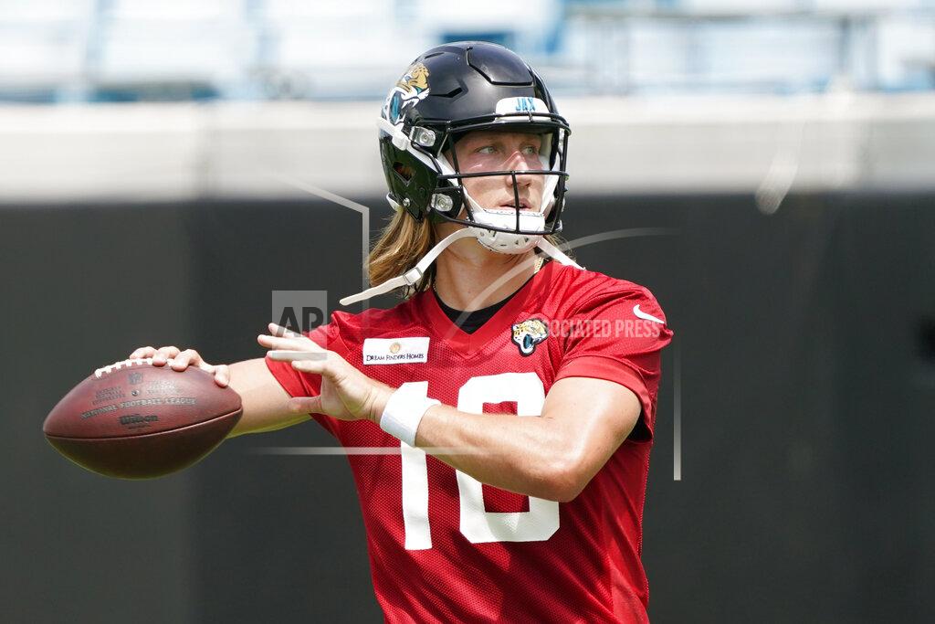 John Raoux Jacksonville Jaguars quarterback Trevor Lawrence (16) throws a pass during an NFL football practice, Monday, May 23, 2022, in Jacksonville, Fla. (AP Photo/John Raoux)