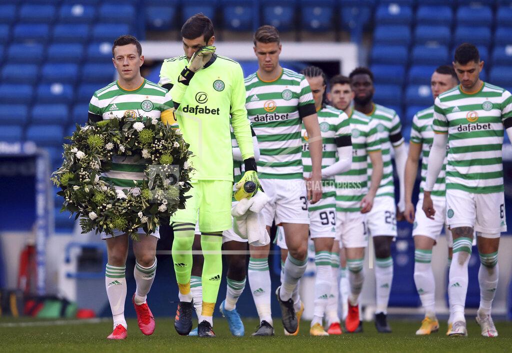 Andrew Milligan Celtic's Callum McGregor carries a wreath out onto the pitch on the 50th anniversary of the Ibrox disaster ahead of the Scottish Premiership match between Rangers and Celtic at Ibrox Stadium, Glasgow, Saturday Jan. 2, 2021. The anniversary marks 50 years since the disaster at the stadium which claimed the lives of 66 people. The fans were crushed on a stairway when barriers collapsed at the Glasgow venue. (Andrew Milligan/PA via AP)