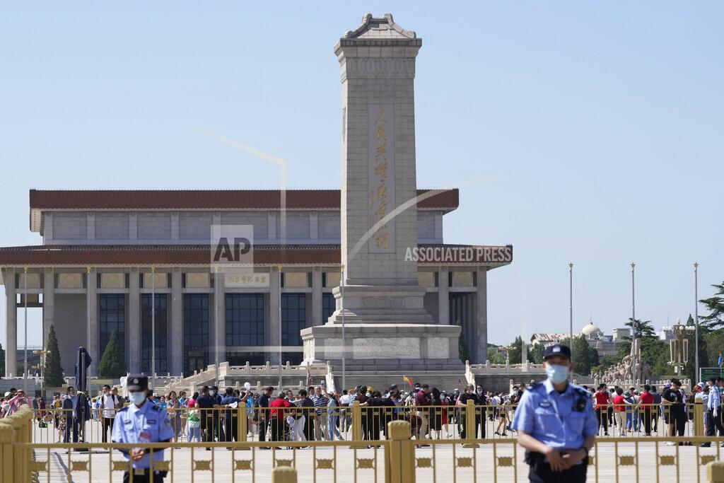 Ng Han Guan Chinese policemen stand on duty as tourists visit Tiananmen Square on the 32nd anniversary of a deadly crackdown on pro-democracy protests in Beijing on Friday, June 4, 2021. Commemorations of the June 4, 1989 crackdown on student-led pro-democracy protests centered on Beijing's Tiananmen Square were especially muted Friday amid pandemic control restrictions and increasing political repression. (AP Photo/Ng Han Guan)