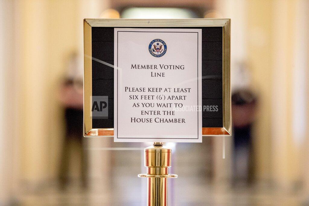 Andrew Harnik A sign in the hallway outside the House Chamber gives social distancing guidelines to lawmakers on Capitol Hill, Thursday, April 23, 2020, in Washington. The House is expected to vote on a nearly $500 billion Coronavirus relief bill. (AP Photo/Andrew Harnik)