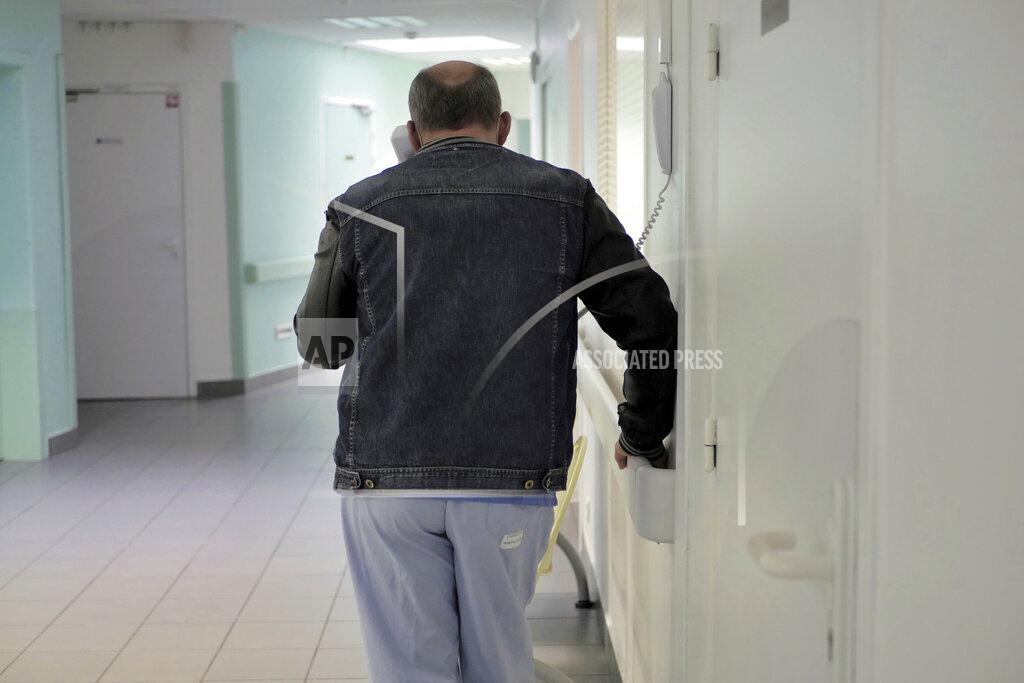 Thibault Camus A patient makes a phone call at the emergency ward of the Rouvray psychiatric hospital, in Rouen, western France, Wednesday, Nov. 25, 2020. Lockdowns that France has used to fight the coronavirus have come at considerable cost to mental health. Surveying points to a surge of depression most acute among people without work, in financial hardship and young adults. (AP Photo/Thibault Camus)
