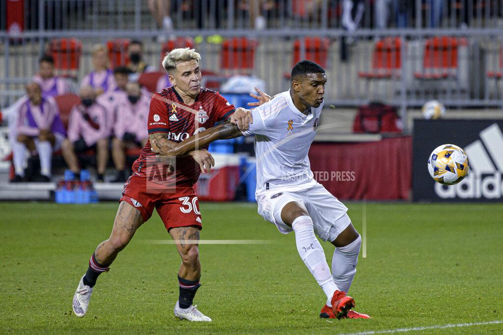 Christopher Katsarov Toronto FC midfielder Yeferson Soteldo (30) is shielded from the ball by IInter Miami defender Christian Makoun during the first half of an MLS soccer match Tuesday, Sept. 14, 2021, in Toronto. (Christopher Katsarov/The Canadian Press via AP)