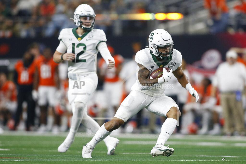 Tim Heitman Baylor running back Abram Smith (7) runs the ball as quarterback Blake Shapen (12) looks on against Oklahoma State in the first half of an NCAA college football game for the Big 12 Conference championship in Arlington, Texas, Saturday, Dec. 4, 2021. (AP Photo/Tim Heitman)