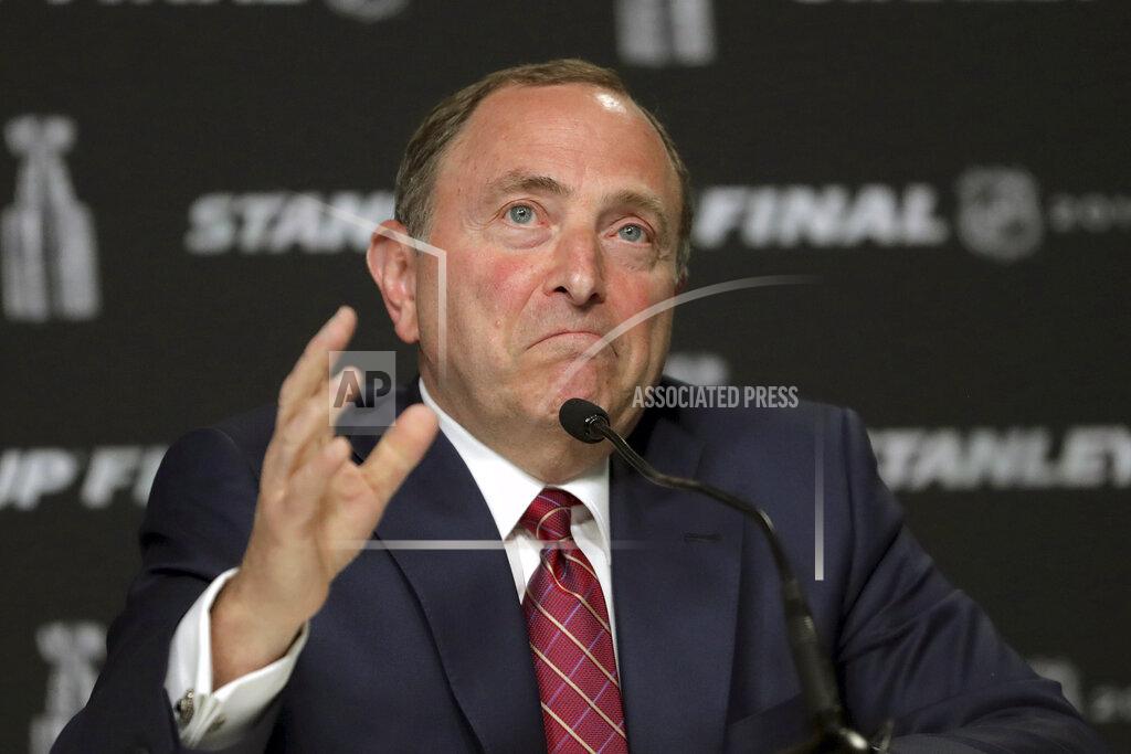 Charles Krupa FILE - In this May 27, 2019, file photo, NHL Commissioner Gary Bettman speaks to the media before Game 1 of the NHL hockey Stanley Cup Final between the St. Louis Blues and the Boston Bruins, in Boston. The NHL nailed down the final details of a playoff format if the season can resume on the same day word came out that another player has tested positive for the coronavirus. (AP Photo/Charles Krupa, File)