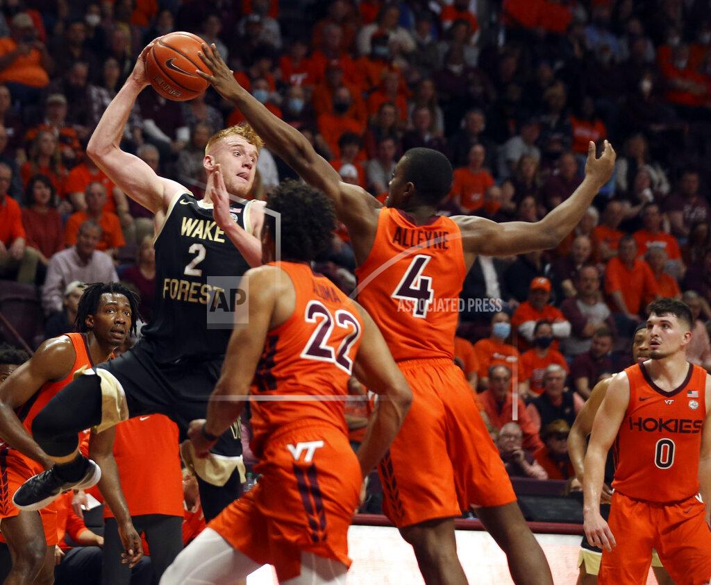 Matt Gentry Cameron Hildreth (2) of Wake Forest looks to pass while defended by Virginia Tech's Keve Aluma (22) and Nahiem Alleyne (4) in the first half of an NCAA college basketball game in Blacksburg, Va. Saturday, Dec. 4 2021. (Matt Gentry/The Roanoke Times via AP)