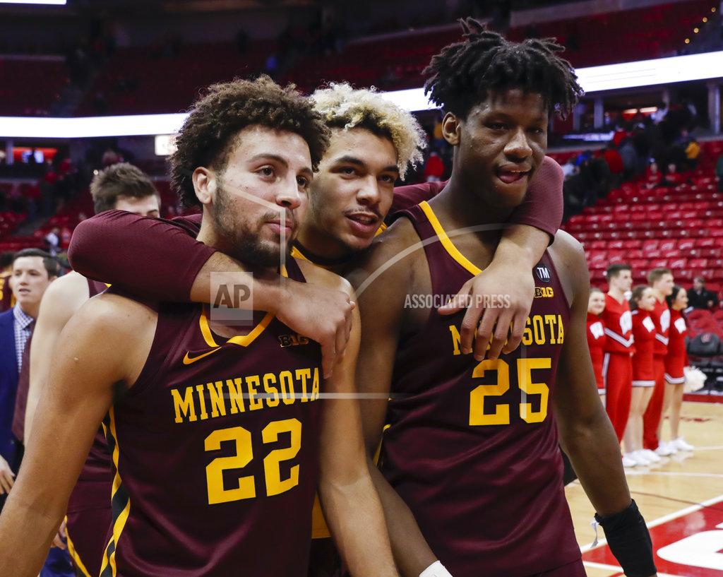 Andy Manis Minnesota's Gabe Kalscheur (22), Jarvis Omersa and Daniel Oturu (25) walk off the court after Minnesotan defeated Wisconsin 59-52 in an NCAA college basketball game Thursday, Jan. 3, 2019, in Madison, Wis. (AP Photo/Andy Manis)