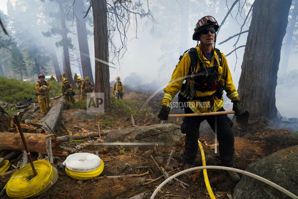 Jae C. Hong Will Fitch, fire captain from Cosumnes Fire Department, and his crew hold a fire line to keep the Caldor Fire from spreading in South Lake Tahoe, Calif., Friday, Sept. 3, 2021. Fire crews took advantage of decreasing winds to battle a California wildfire near popular Lake Tahoe and were even able to allow some people back to their homes but dry weather and a weekend warming trend meant the battle was far from over.(AP Photo/Jae C. Hong)