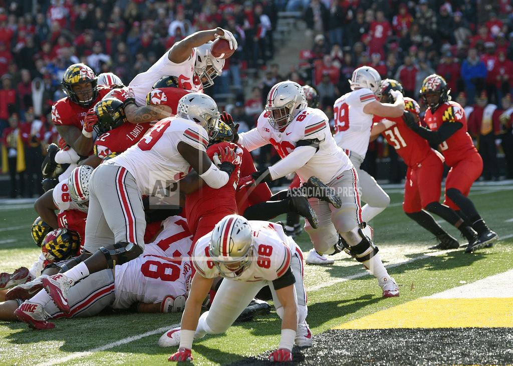 Nick Wass Ohio State running back J.K. Dobbins, top left, stretches for a touchdown during the first half of an NCAA football game against Maryland, Saturday, Nov. 17, 2018, in College Park, Md. (AP Photo/Nick Wass)