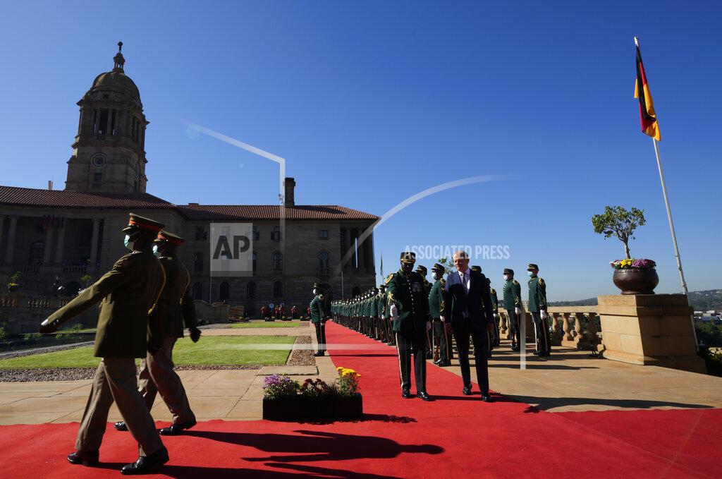 Themba Hadebe German Chancellor Olaf Scholz inspects a guard of honour during the official welcoming ceremony at the Union Building in Pretoria, South Africa, Tuesday, May 24, 2022. (AP Photo/Themba Hadebe)