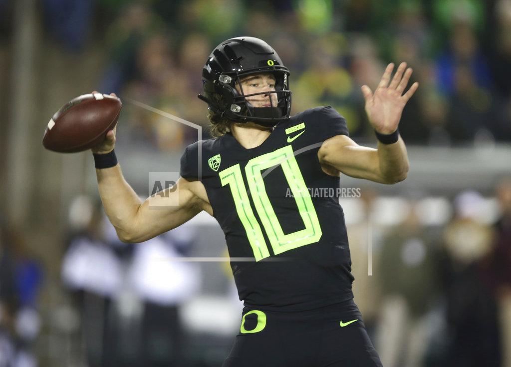 Chris Pietsch File-This Nov. 17, 2018, file photo shows Oregon quarterback Justin Herbert throwing down field against Arizona State during the first quarter of an NCAA college football game in Eugene, Ore. Herbert says he’ll return for his senior season. Herbert announced his decision on Wednesday, Dec. 26, 2018, before the Oregon left Eugene for the Redbox Bowl. Oregon plays Michigan State on Monday. (AP Photo/Chris Pietsch, File)
