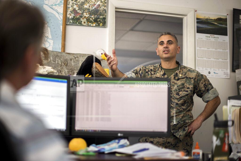 Stephen B. Morton Marine Corps Recruiting Depot Environmental Director, Maj. Marc Blair, right, speak with Natural Resources Manager John Holloway, Jr. in his office, Wednesday, May 11, 2022, in Parris Island, S.C. (AP Photo/Stephen B. Morton)