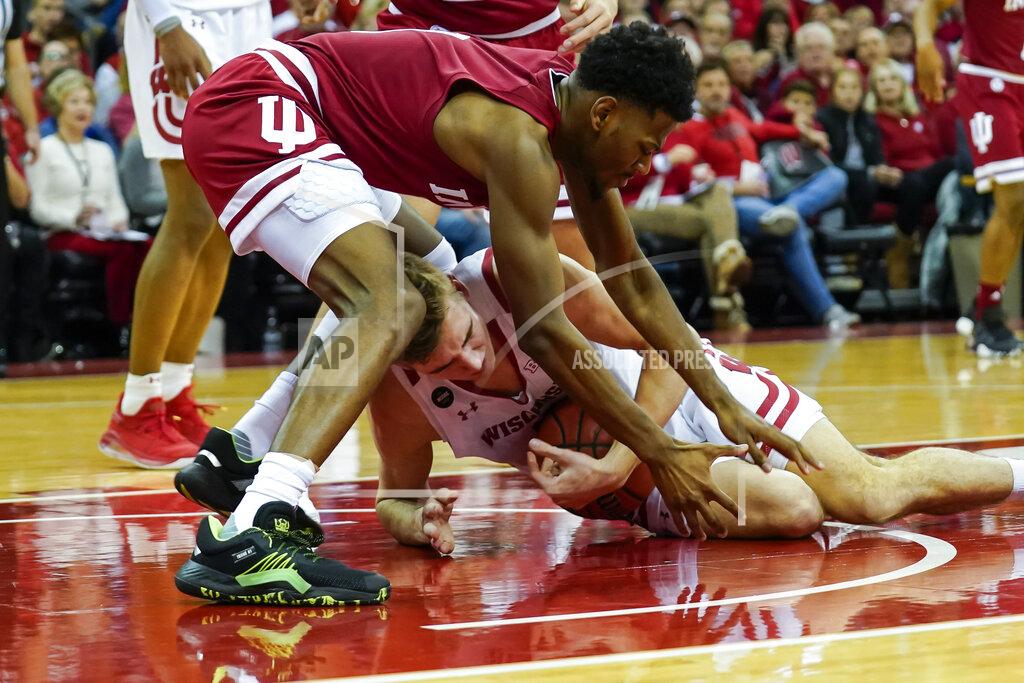 Andy Manis Wisconsin's Tyler Wahl, bottom, and Indiana's Aljami Durham (1) battle for a loose ball during the second half of an NCAA college basketball game Saturday, Dec. 7, 2019, in Madison, Wis. Wisconsin won 84-64. (AP Photo/Andy Manis)