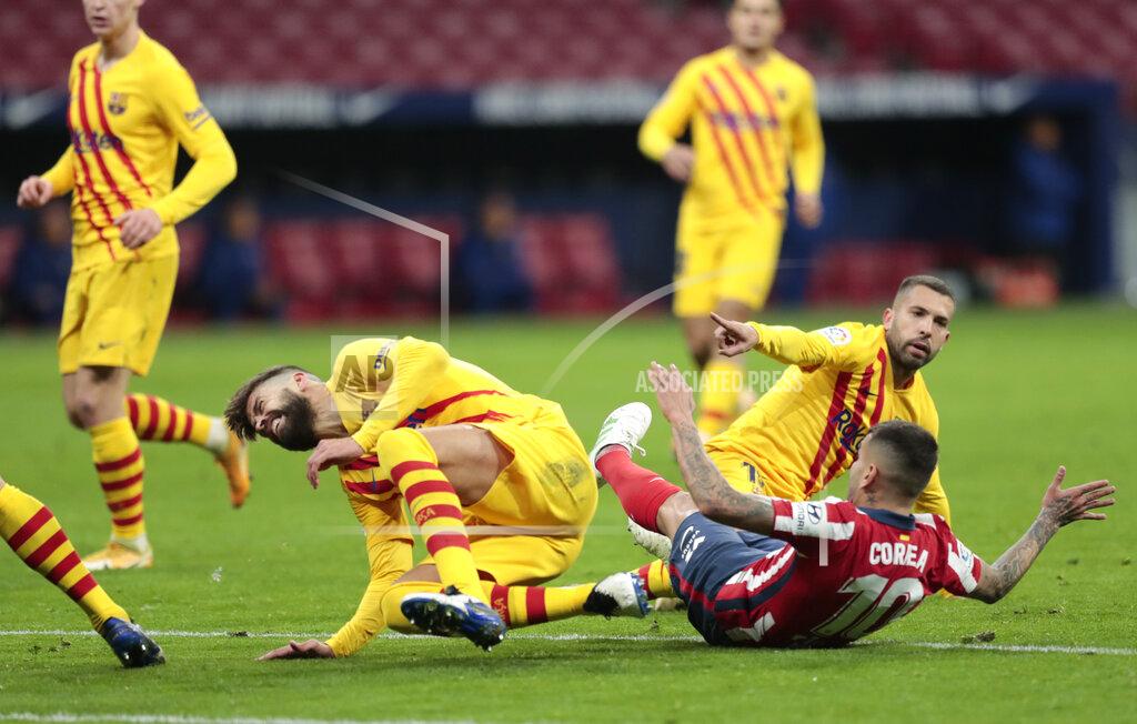 Bernat Armangue Barcelona's Gerard Pique, left, reacts after getting an injury in a challenge with Atletico Madrid's Angel Correa during the Spanish La Liga soccer match between Atletico Madrid and FC Barcelona at the Wanda Metropolitano stadium in Madrid, Spain, Saturday, Nov. 21, 2020. (AP Photo/Bernat Armangue)