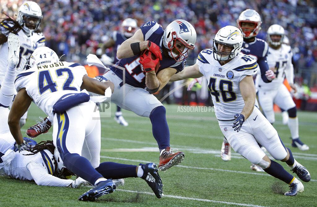 Steven Senne Los Angeles Chargers linebackers Uchenna Nwosu (42) and linebacker Nick Dzubnar (48) close in to tackle New England Patriots wide receiver Julian Edelman (11) during the first half of an NFL divisional playoff football game, Sunday, Jan. 13, 2019, in Foxborough, Mass. (AP Photo/Steven Senne)