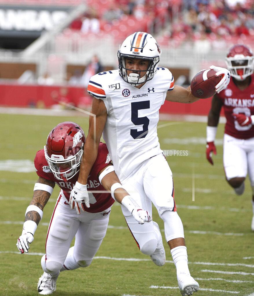 Michael Woods Auburn receiver Anthony Schwartz is knocked out of bounds by Arkansas defender McTelvin Agim during the second half of an NCAA college football game, Saturday, Oct. 19, 2019 in Fayetteville, Ark. (AP Photo/Michael Woods)