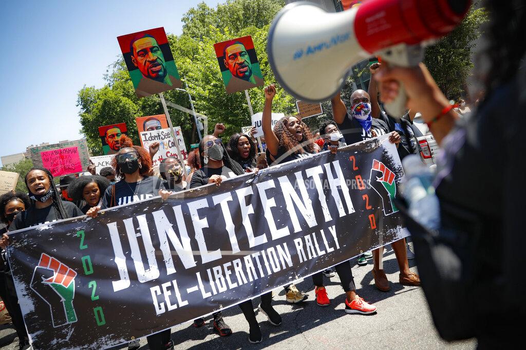 FILE- In this June 19, 2020 file photo, protesters chant as they march after a Juneteenth rally at the Brooklyn Museum, Friday, June 19, 2020, in the Brooklyn borough of New York. On Thursday, July 23, 2020, New York State passed a bill to designate June 19 as Juneteenth to commemorate the emancipation of slaves in the U.S. (AP Photo/John Minchillo, File)