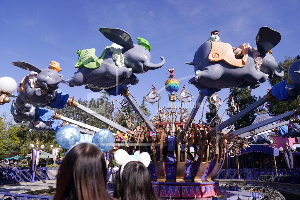 Jae Hong Guests ride the Dumbo ride at Disneyland in Anaheim, Calif., Friday, April 30, 2021. The iconic theme park in Southern California that was closed under the state's strict virus rules swung open its gates Friday and some visitors came in cheering and screaming with happiness. (AP Photo/Jae Hong)