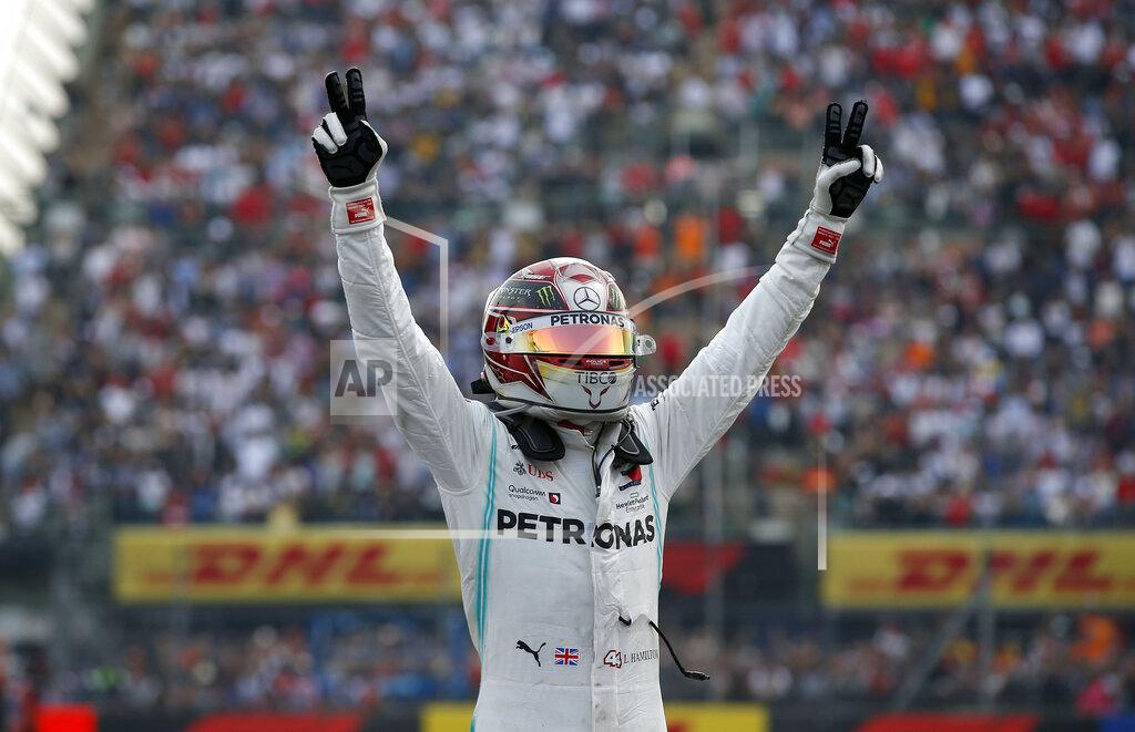 Mercedes driver Lewis Hamilton, of Britain, celebrates after his victory in the Formula One Mexico Grand Prix auto race at the Hermanos Rodriguez racetrack in Mexico City, Sunday, Oct. 27, 2019. (AP Photo/Eduardo Verdugo)