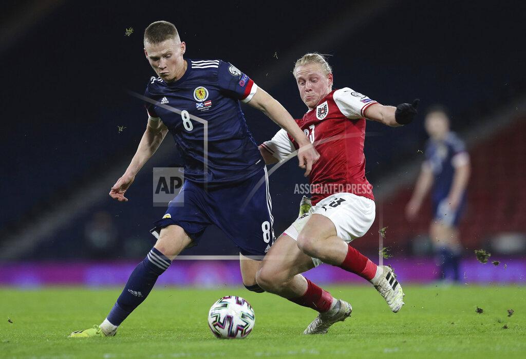 Jane Barlow Scotland's Scott McTominay, left, and Austria's Xaver Schlager during their 2022 World Cup qualifying soccer match between Scotland and Austria, at Hampden Park in Glasgow, Scotland, Thursday March 25, 2021. (Jane Barlow/PA via AP)