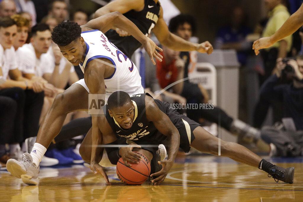 Charlie Riedel Kansas' Ochai Agbaji, left, and Colorado's McKinley Wright IV chase the ball during the first half of an NCAA college basketball game Saturday, Dec. 7, 2019, in Lawrence, Kan. (AP Photo/Charlie Riedel)
