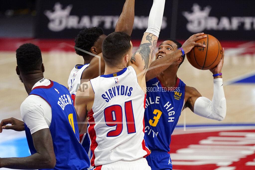Carlos Osorio Denver Nuggets guard Shaquille Harrison (3) is defended by Detroit Pistons guard Deividas Sirvydis (91) and guard Saben Lee during the first half of an NBA basketball game, Friday, May 14, 2021, in Detroit. (AP Photo/Carlos Osorio)