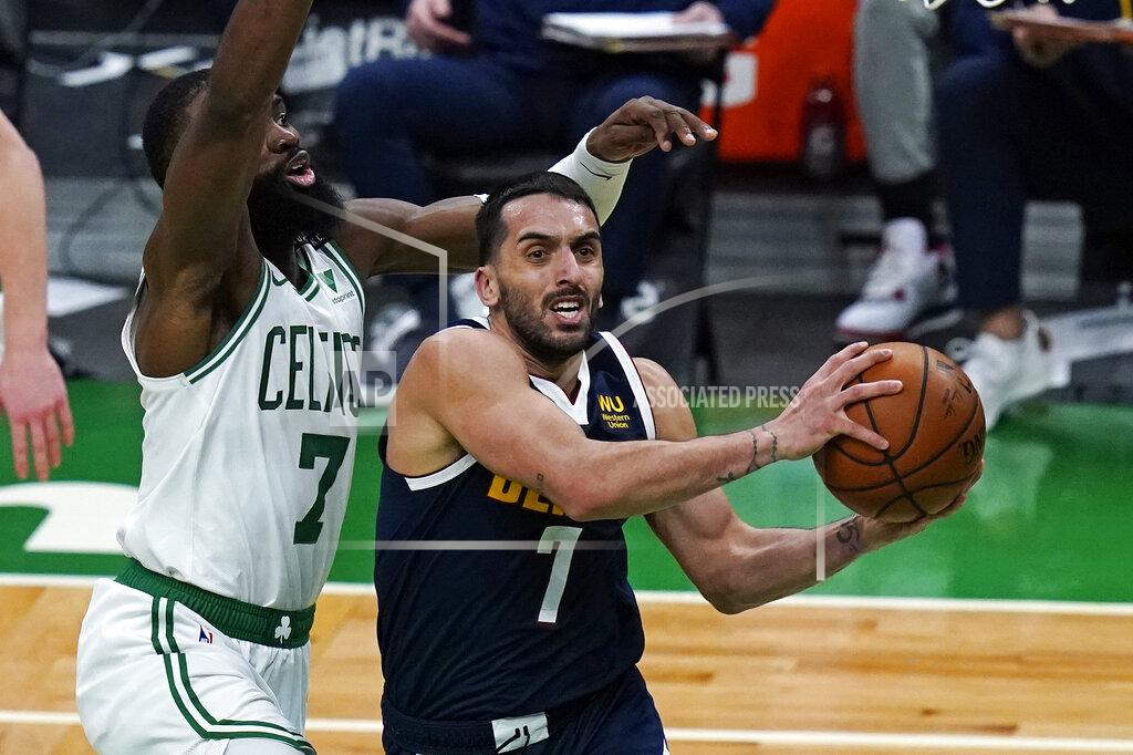 Charles Krupa Denver Nuggets guard Facundo Campazzo, right, drives to the basket against Boston Celtics guard Jaylen Brown, left, during the first half of an NBA basketball game, Tuesday, Feb. 16, 2021, in Boston. (AP Photo/Charles Krupa)