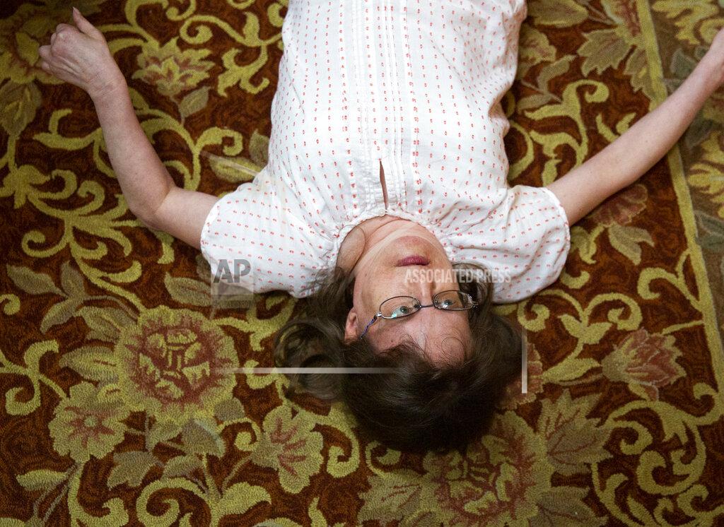 Sophia Germer Jen Dwyer, a 44-year-old woman with intellectual and developmental disabilities, dances on the floor to Mariah Carey Christmas carols at her home in Metairie, La., Friday, Sept. 17, 2021. (Sophia Germer/The Times-Picayune/The New Orleans Advocate via AP)