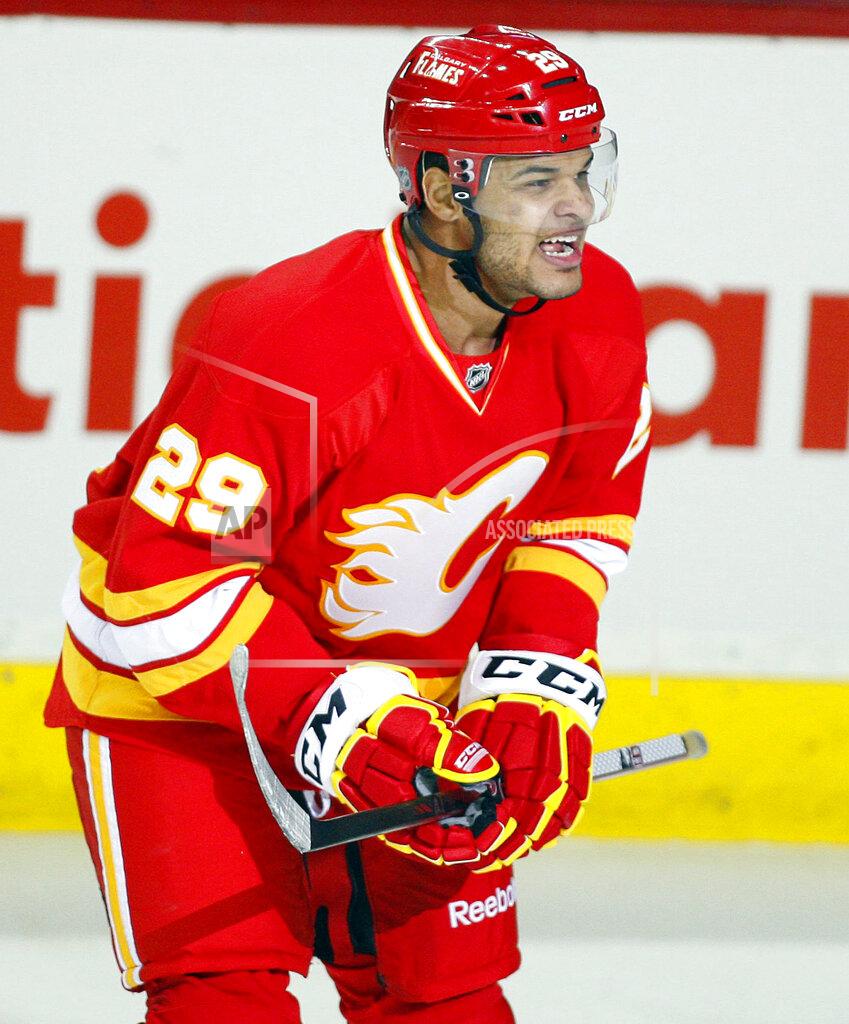 Jeff Mcintosh FILE - In this April 7, 2012, file photo, Calgary Flames' Akim Aliu, a Nigerian-born Canadian, celebrates his goal during first period NHL hockey action against the Anaheim Ducks, in Calgary, Alberta. Calgary Flames general manager Brad Treliving said the team is looking into an accusation that head coach Bill Peters directed racial slurs toward a Nigerian-born hockey player a decade ago in the minor leagues, then arranged for the player’s demotion when he complained. Akim Aliu tweeted Monday, Nov. 25, 2019, that Peters “dropped the N bomb several times towards me in the dressing room in my rookie year because he didn’t like my choice of music.” (AP Photo/The Canadian Press, Jeff McIntosh, File)
