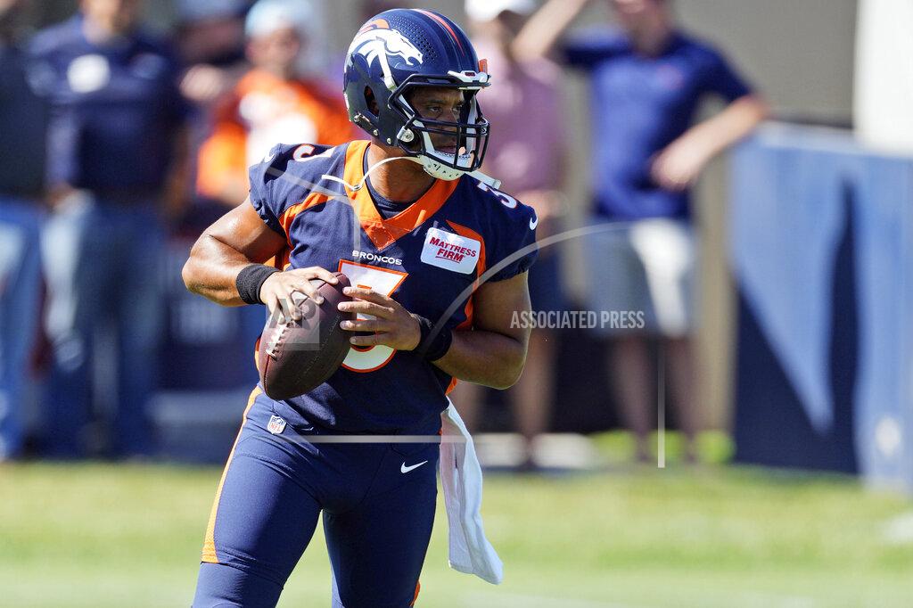 David Zalubowski Denver Broncos quarterback Russell Wilson takes part in drills during the opening session of the NFL football team's training camp Wednesday, July 27, 2022, in Centennial, Colo. (AP Photo/David Zalubowski)