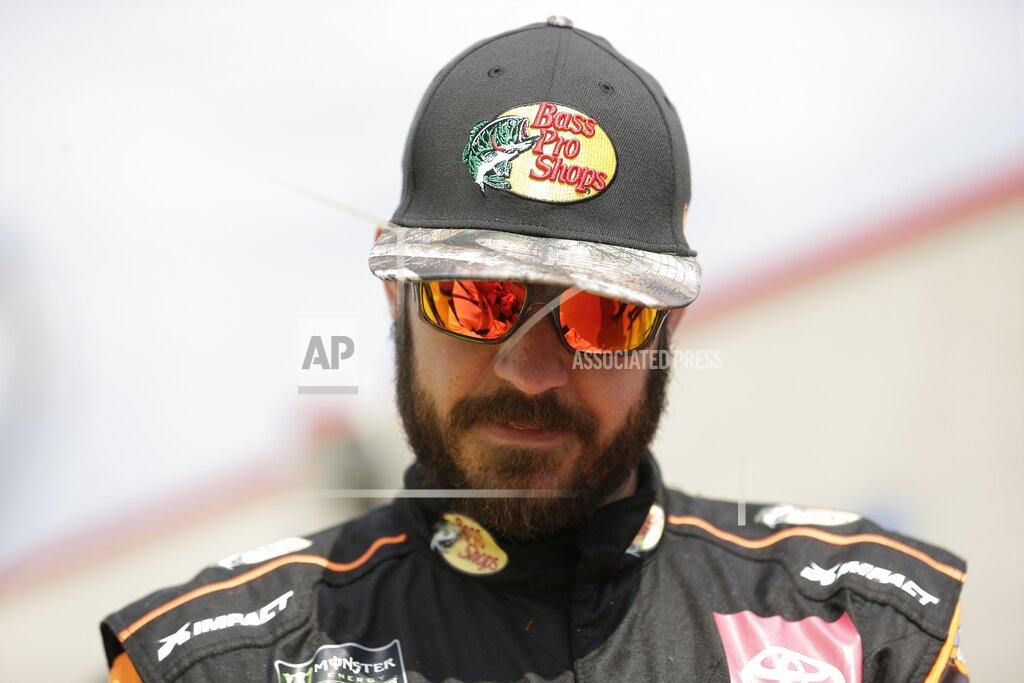 Gerry Broome Martin Truex Jr. pauses to sign an autograph for a fan during practice for Sunday's NASCAR Cup Series auto race at Charlotte Motor Speedway in Concord, N.C., Saturday, Sept. 28, 2019. (AP Photo/Gerry Broome)