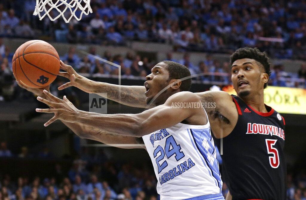 Gerry Broome North Carolina's Kenny Williams (24) drives to the basket while Louisville's Malik Williams (5) defends during the first half of an NCAA college basketball game in Chapel Hill, N.C., Saturday, Jan. 12, 2019. (AP Photo/Gerry Broome)