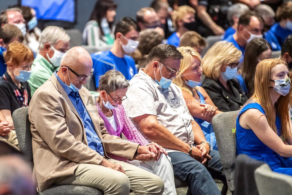 Alexandra Wimley FILE—In this file photo from Sept. 9, 2020, people attending an event with Vice President Mike Pence, pray before he took the stage to speak to Marjorie Dannenfelser, president of the Susan B. Anthony List, an anti-abortion group, at Cornerstone Ministries church, in Export, Pa. a Pittsburgh suburb. Trump's selection of Mike Pence to be his vice president has often been cited as a turning point in getting evangelicals, who make up about 1 in 5 voters, to rally behind Trump four years ago. (Alexandra Wimley/Pittsburgh Post-Gazette via AP, File)