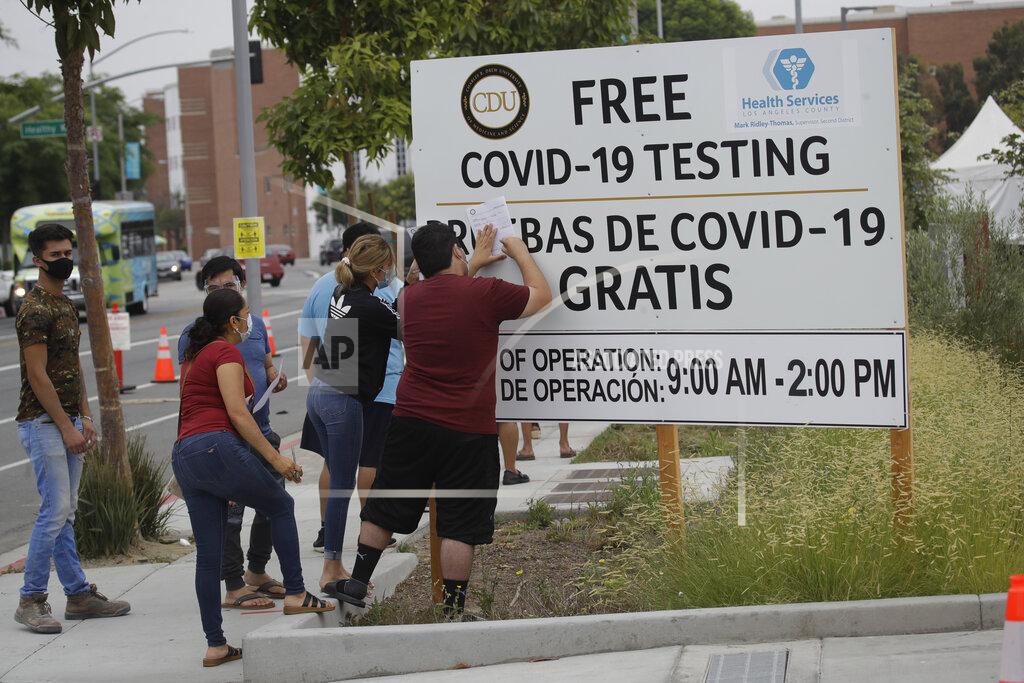 Marcio Jose Sanchez FILE - In this July 22, 2020, file photo, people fill out forms at a mobile testing site at the Charles Drew University of Medicine and Science during the coronavirus outbreak in Los Angeles. California has signed a contract worth up to $1.4 billion with a company to provide a significantly cheaper coronavirus test that will allow the state to eventually more than double the number of people tested to 250,000 per day, Gov. Gavin Newsom announced Wednesday, Aug. 26, 2020. (AP Photo/Marcio Jose Sanchez, File)