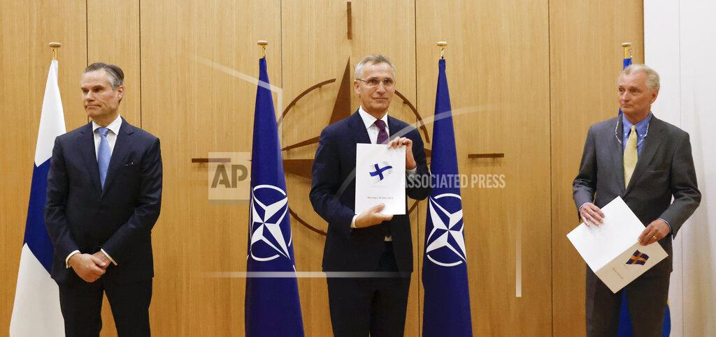 Johanna Geron Finland's Ambassador to NATO Klaus Korhonen, NATO Secretary-General Jens Stoltenberg and Sweden's Ambassador to NATO Axel Wernhoff attend a ceremony to mark Sweden's and Finland's application for membership in Brussels, Belgium, Wednesday May 18, 2022. NATO Secretary-General Jens Stoltenberg said that the military alliance stands ready to seize a historic moment and move quickly on allowing Finland and Sweden to join its ranks, after the two countries submitted their membership requests. (Johanna Geron/Pool via AP)