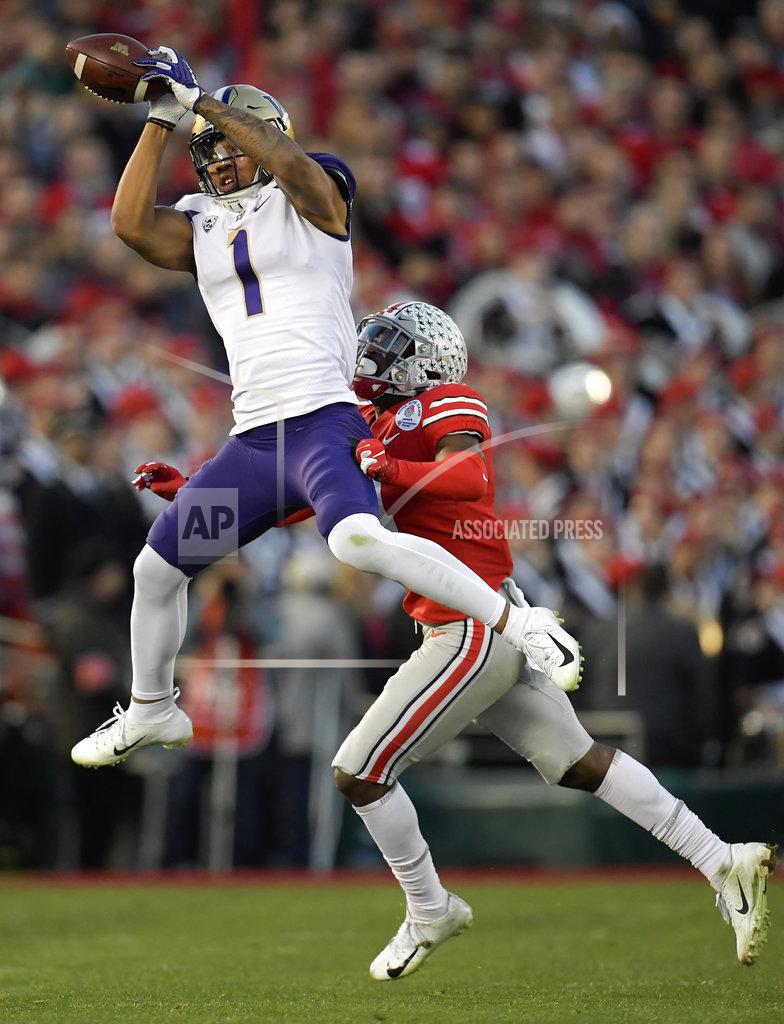 Mark J. Terrill Washington tight end Hunter Bryant catches a pass over Ohio State safety Jordan Fuller during the second half of the Rose Bowl NCAA college football game Tuesday, Jan. 1, 2019, in Pasadena, Calif. (AP Photo/Mark J. Terrill)