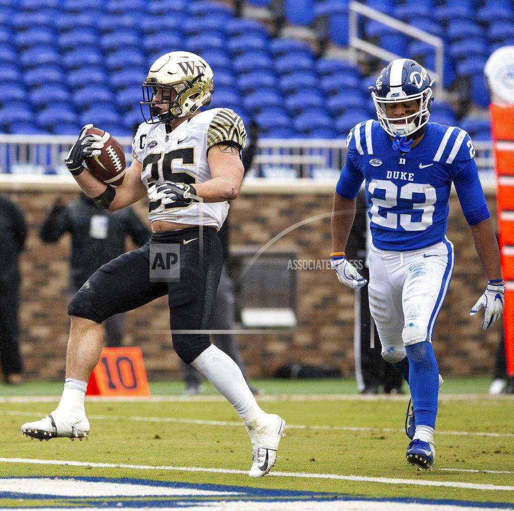 Ben Mckeown Wake Forest's Willy Bemiss (35) scores a touchdown ahead of Duke's Lummie Young IV (23) during the first half of an NCAA college football game in Durham, N.C., Saturday, Nov. 24, 2018. (AP Photo/Ben McKeown)