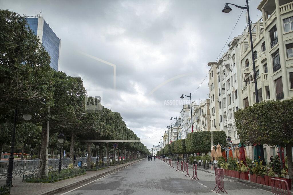 Mosa'ab Elshamy Tunis' landmark Avenue Habib Bourgiba, where massive protests took place in 2011, is empty on the tenth anniversary of the uprising, due to a national lockdown after a surge in COVID-19 cases, in Tunis, Thursday, Jan. 14, 2021. Tunisia is commemorating the 10th anniversary since the flight into exile of its iron-fisted leader, Zine El Abidine Ben Ali, pushed from power in a popular revolt that foreshadowed the so-called Arab Spring. But there will be no festive celebrations Thursday marking the revolution in this North African nation, ordered into lockdown to contain the coronavirus. (AP Photo/Mosa'ab Elshamy)