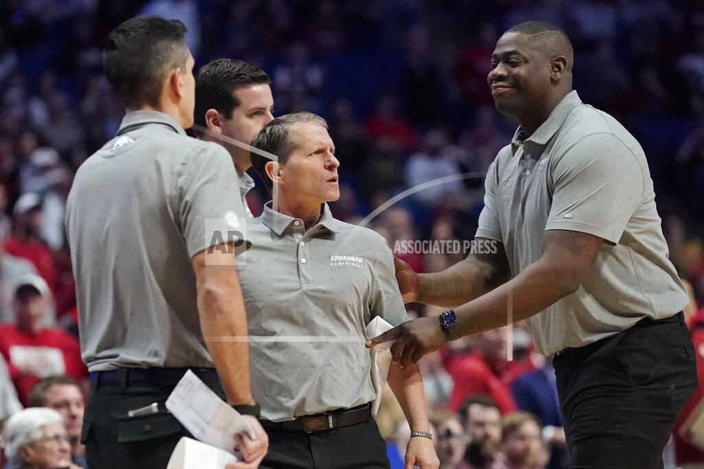 Sue Ogrocki Arkansas head coach Eric Musselman, center, is held back from the officials after being ejected in the second half of an NCAA college basketball game against Oklahoma, Saturday, Dec. 11, 2021, in Tulsa, Okla. (AP Photo/Sue Ogrocki)