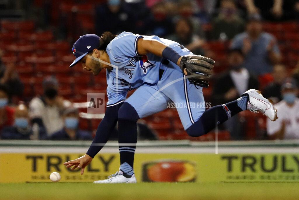Winslow Townson Toronto Blue Jays shortstop Bo Bichette bobbles a ground ball hit by Boston Red Sox's J.D. Martinez for an error during the fifth inning of a baseball game Tuesday, April 20, 2021, at Fenway Park in Boston. (AP Photo/Winslow Townson)