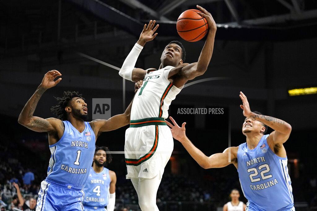 Lynne Sladky Miami forward Anthony Walker, center, goes for a rebound against North Carolina guard Leaky Black (1) and forward Justin McKoy (22) during the second half of an NCAA college basketball game, Tuesday, Jan. 18, 2022, in Coral Gables, Fla. Miami won 85-57. (AP Photo/Lynne Sladky)